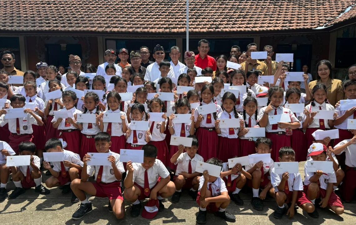 Gubernur Bali Wayan Koster saat memberi santunan untuk 66 siswa SD N 5 Banjar yang terdampak banjir. -IST/BALITOPIK.COM